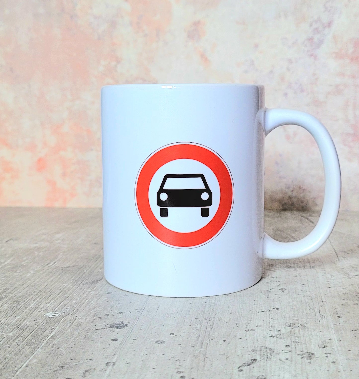 Close-up of traffic-style symbol on white ceramic mug