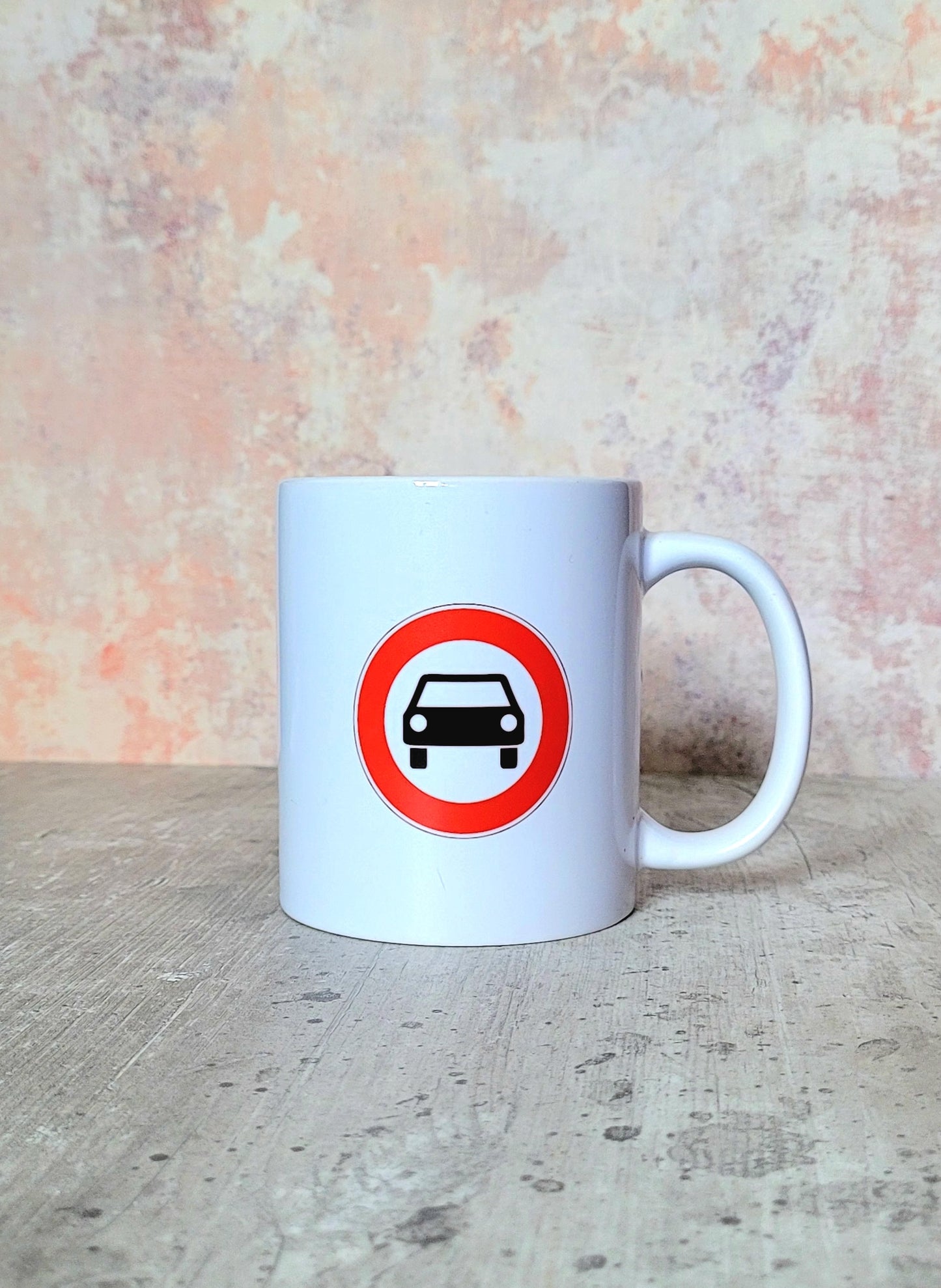 Rear view of mug with UK car symbol road sign design