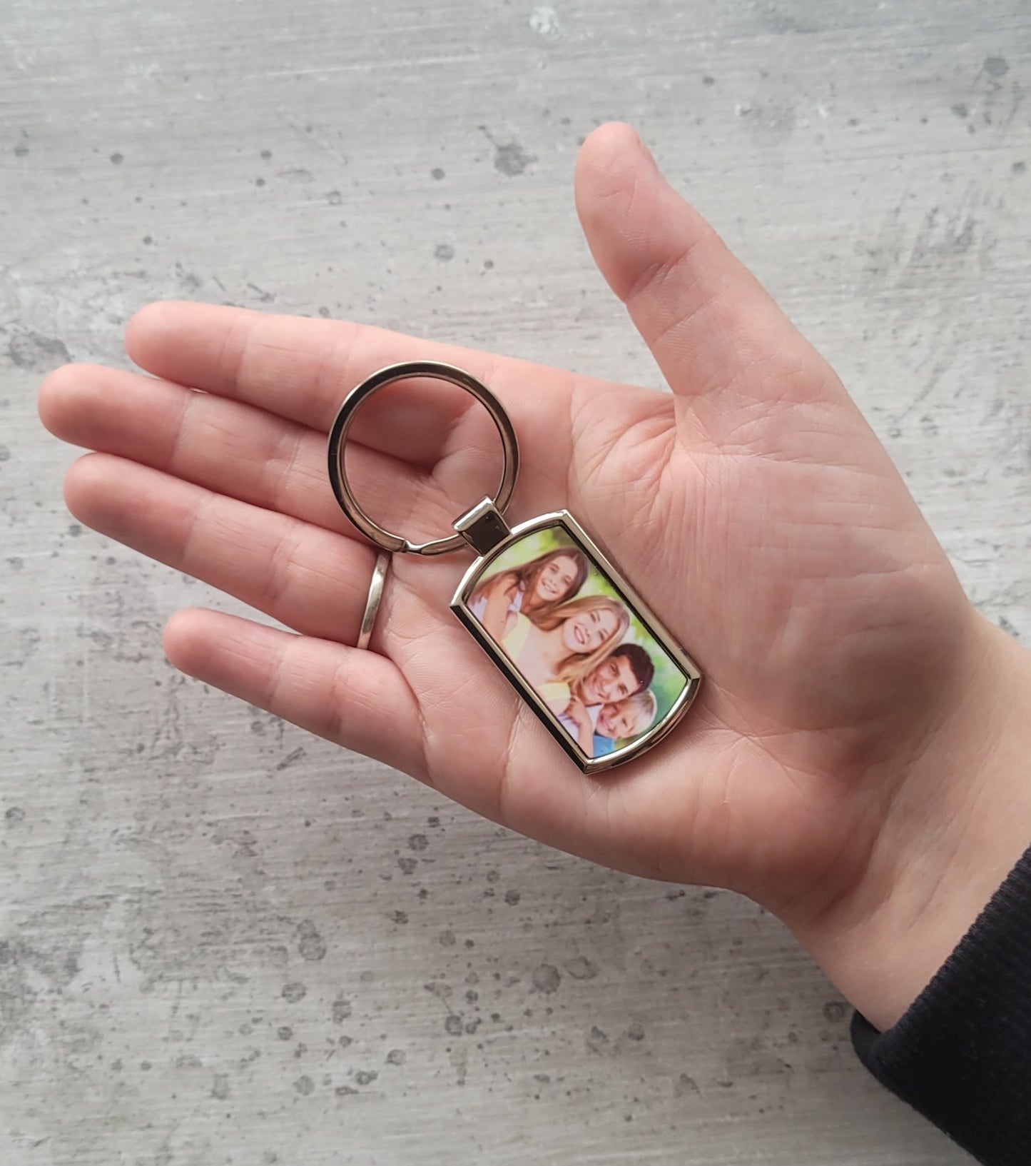 Personalised photo keyring in hand for size reference