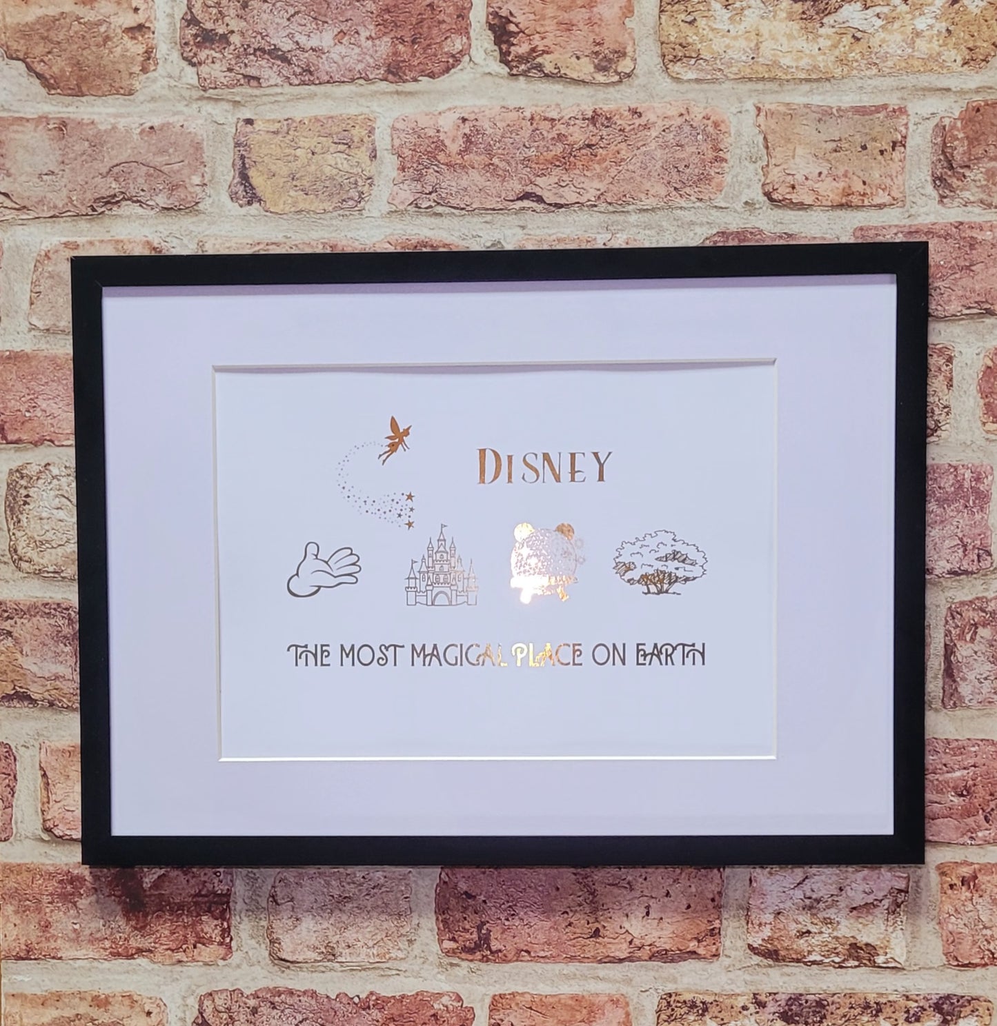 gold foil Disney-inspired artwork inside black photo frame