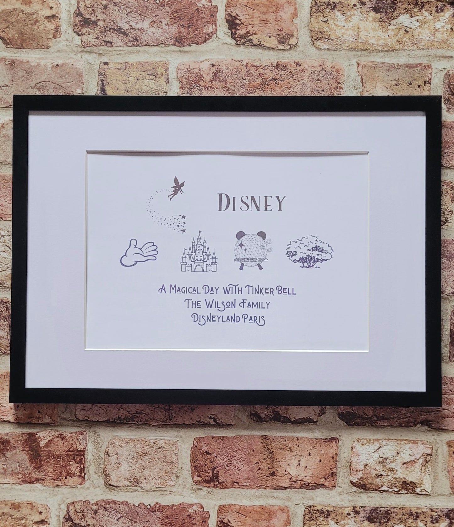 Disney-inspired family keepsake framed in white frame with shimmering foil