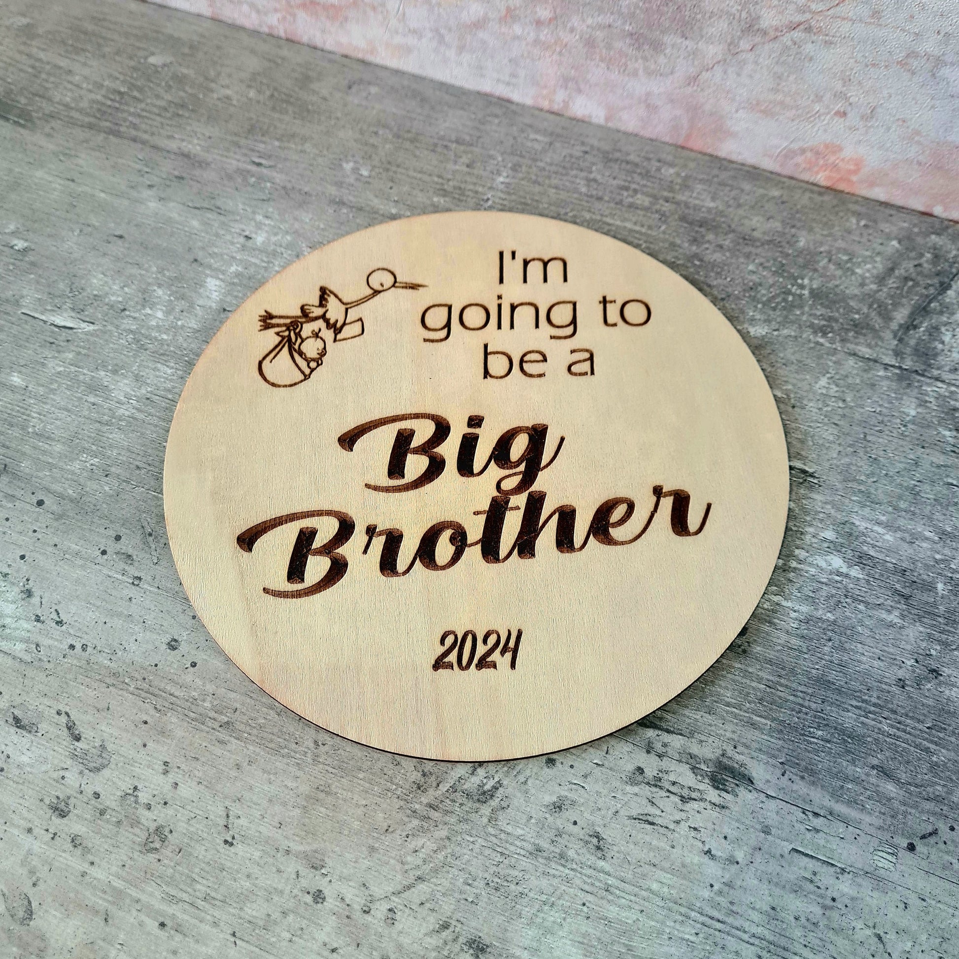 Personalised wooden sibling pregnancy announcement sign engraved with custom name