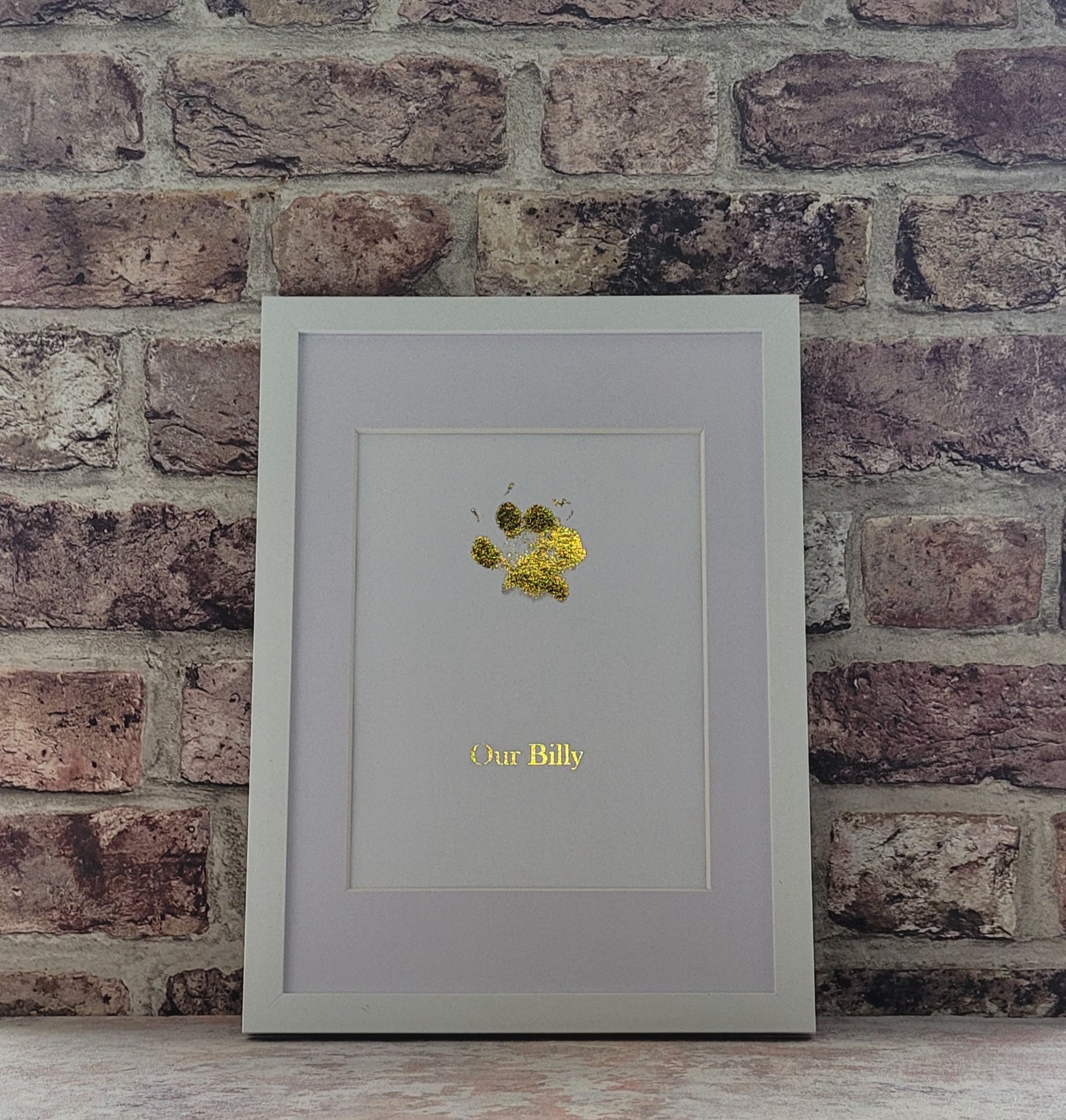 Gold paw print in a frame