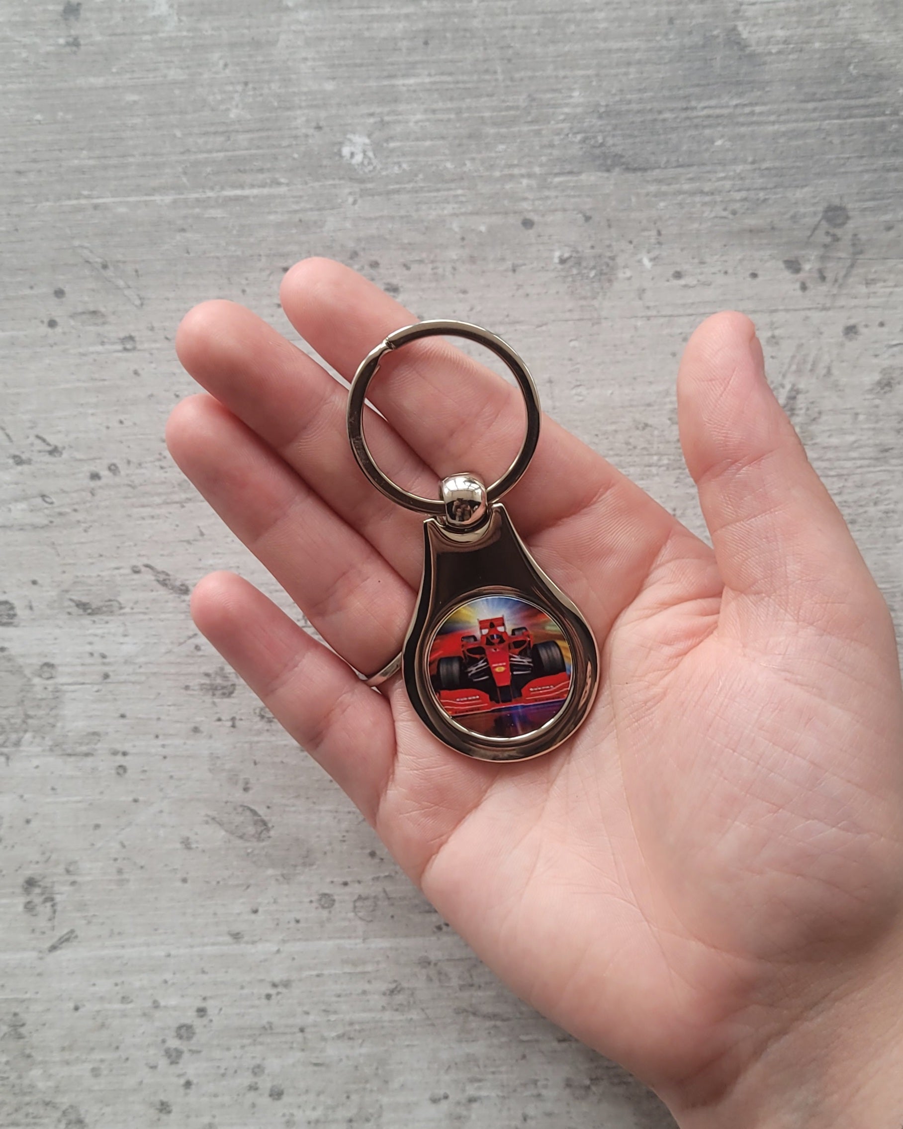 Round polished metal photo keyring styled flatlay