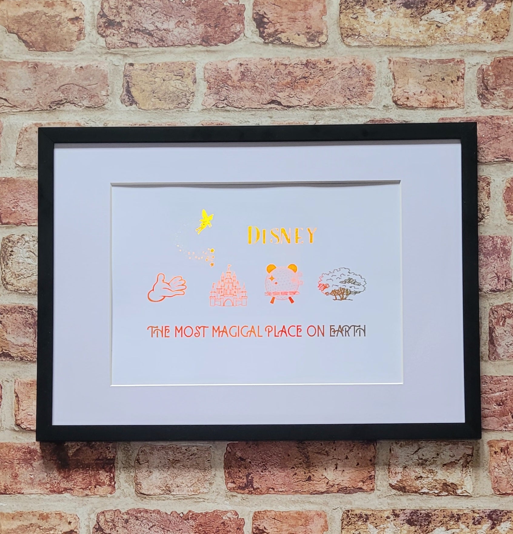 Disney-inspired family keepsake framed in white frame with shimmering foil