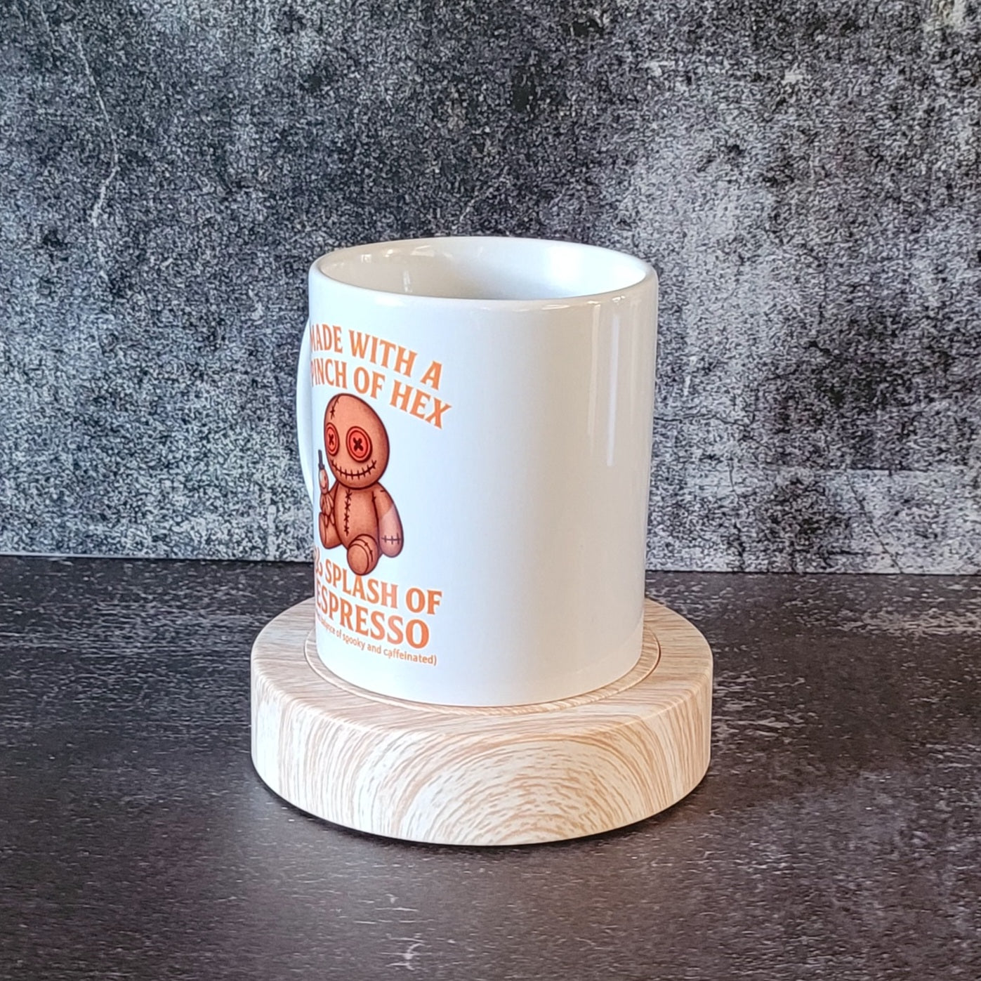 Witchy espresso mug displayed on wooden stand.