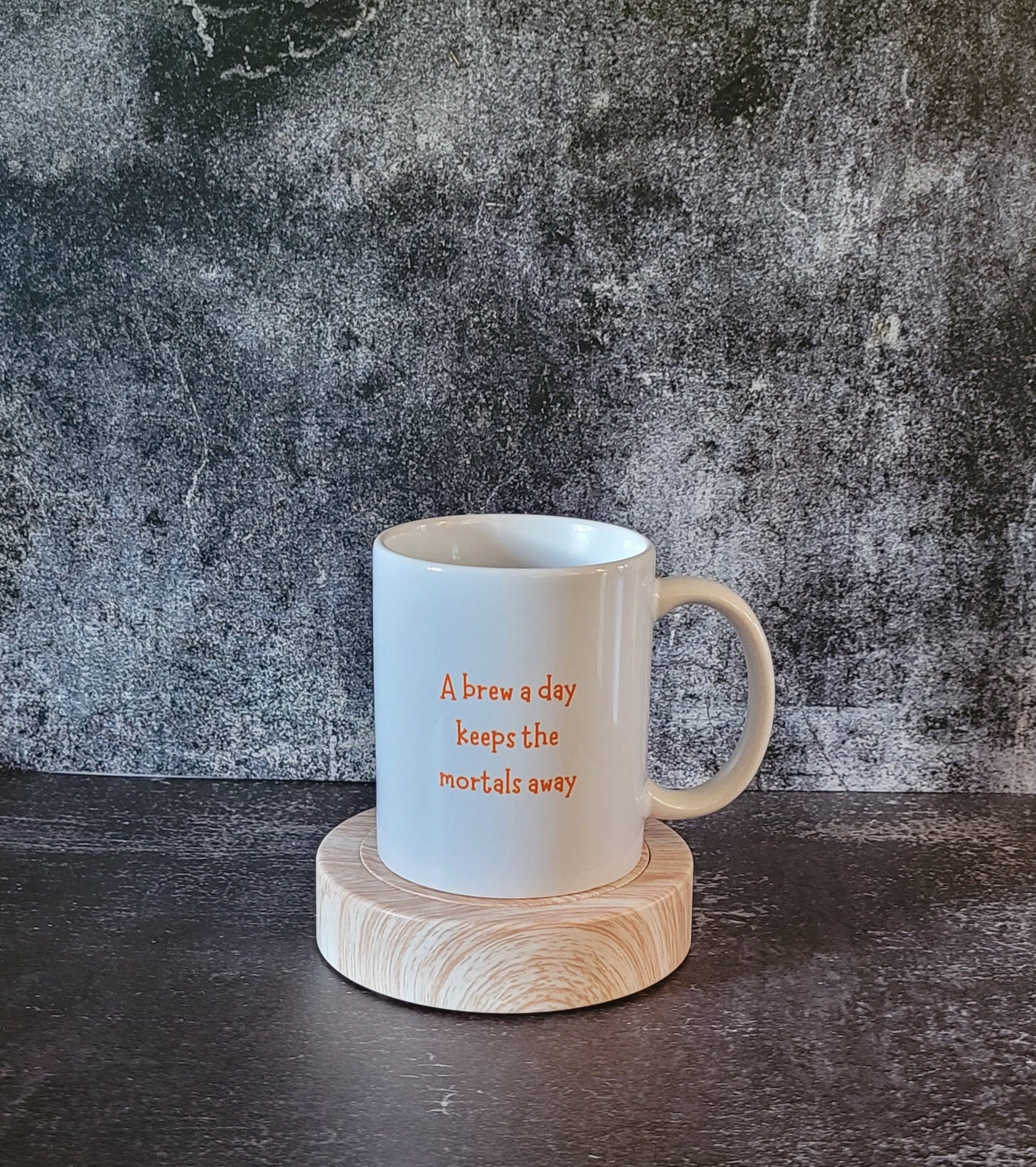 Back of mug with witchy quote: A brew a day keeps the mortals away.