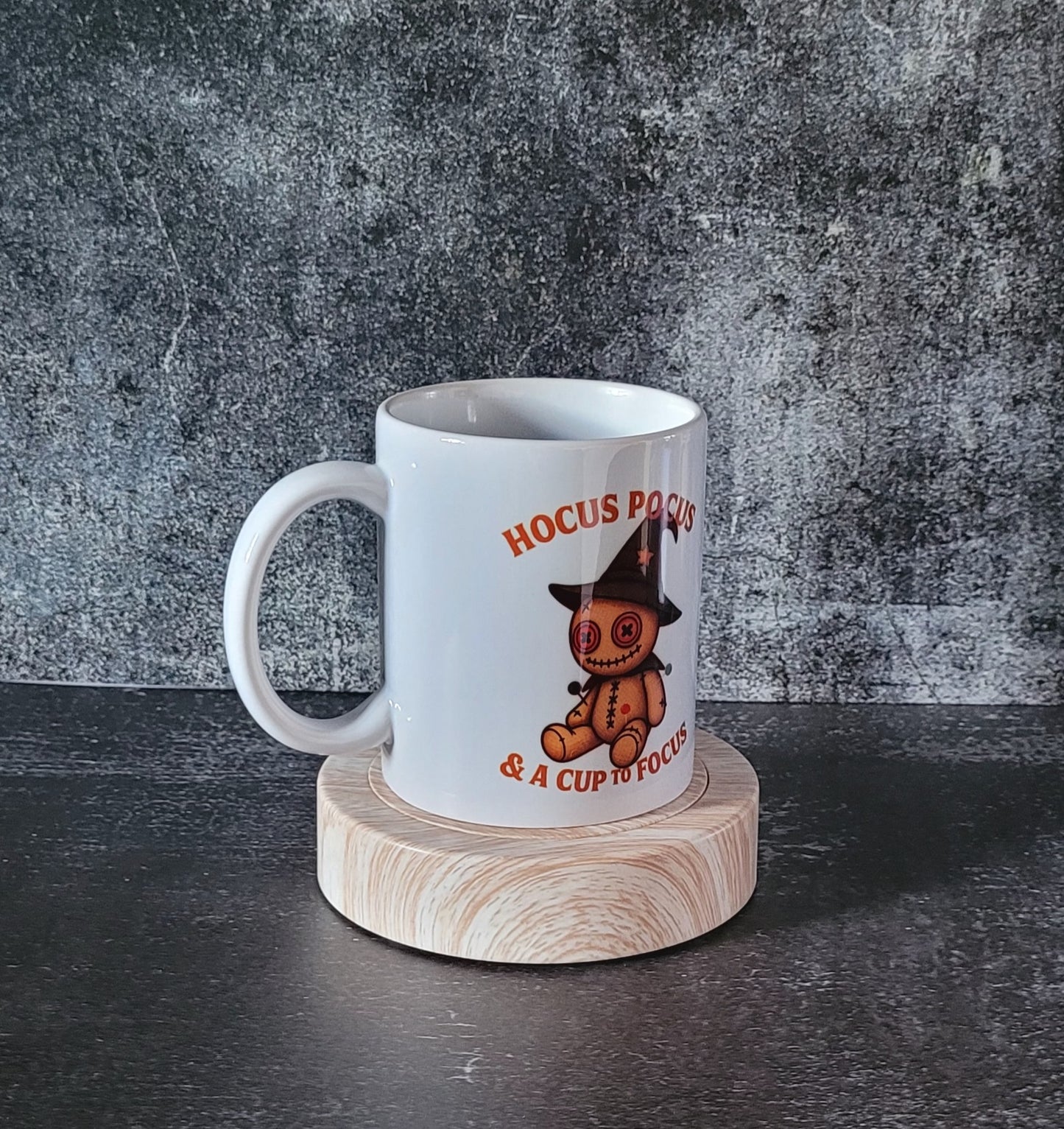 White ceramic Halloween mug with voodoo doll witch design.