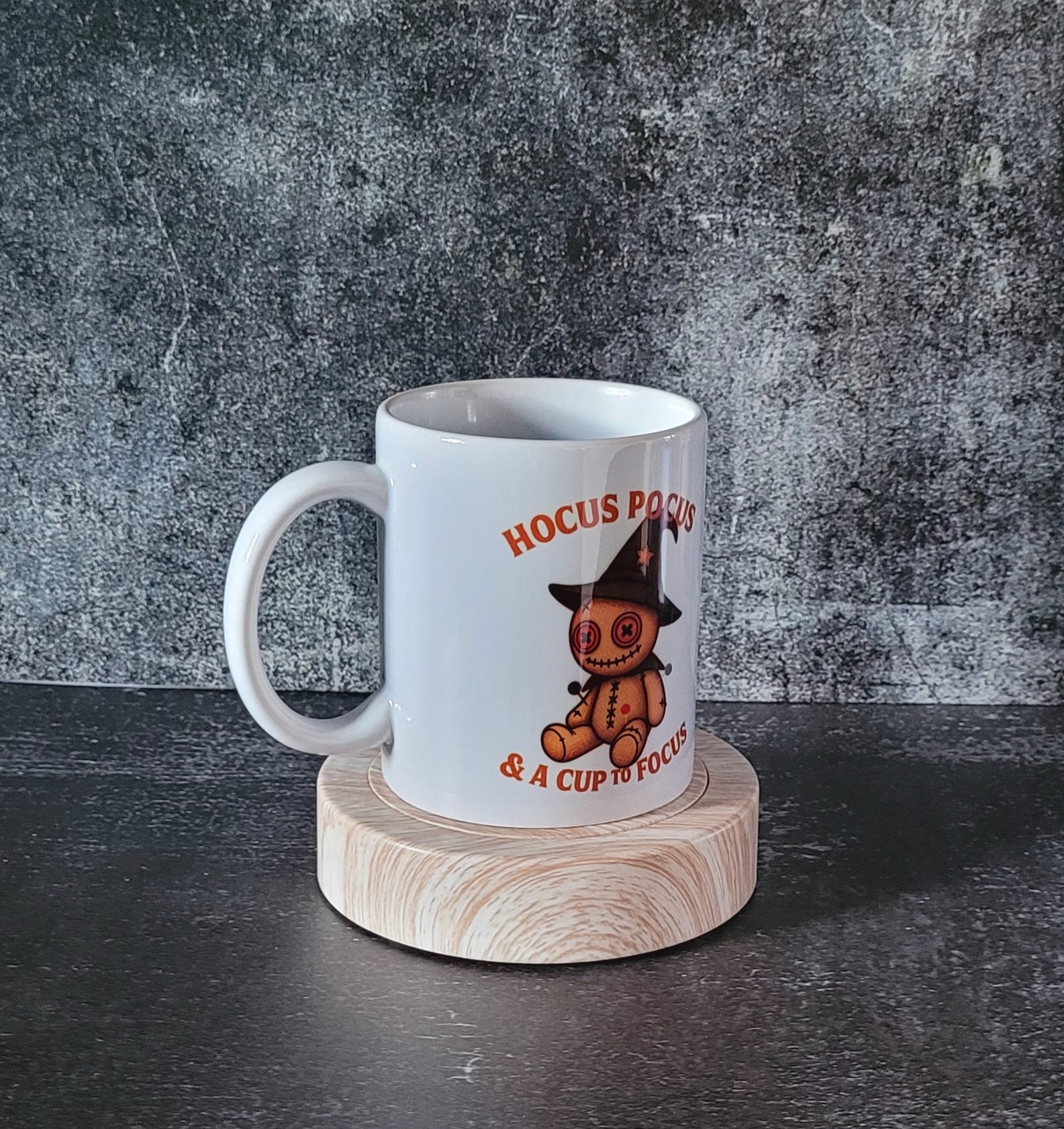 White ceramic Halloween mug with voodoo doll witch design.