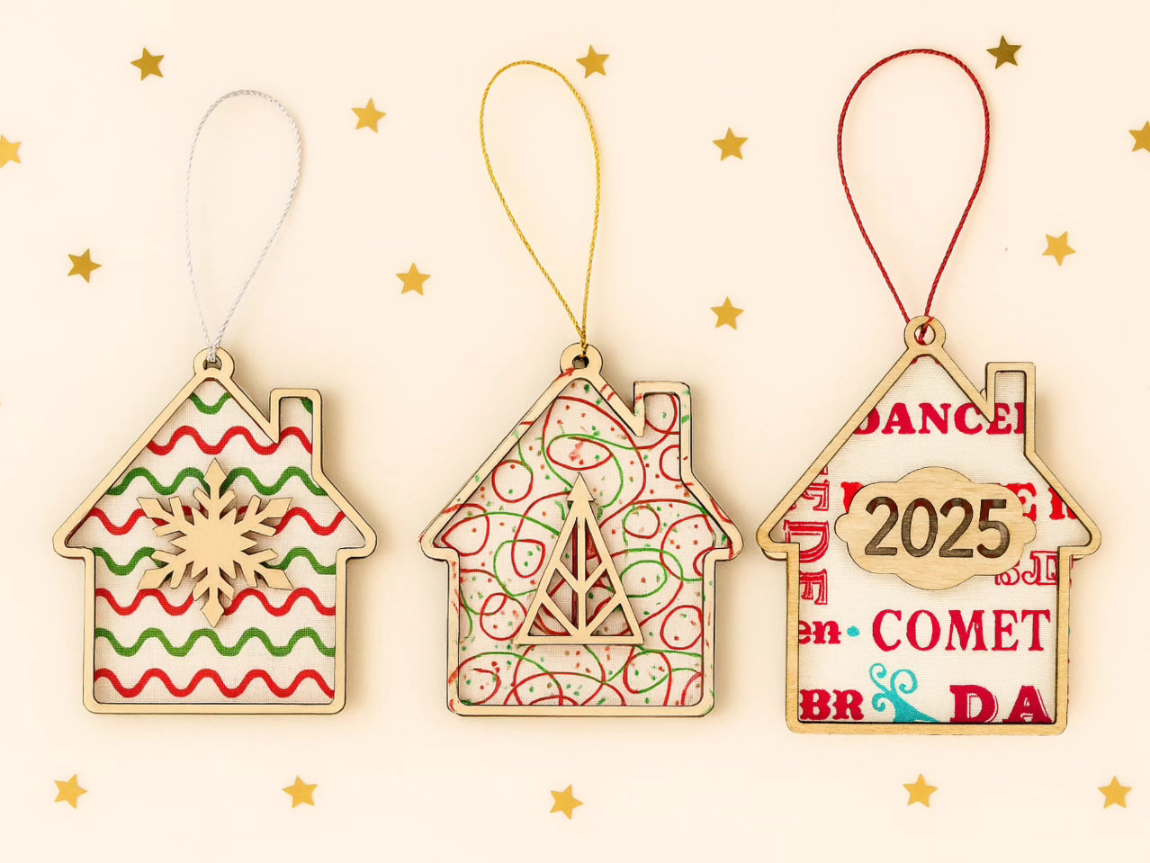 “Pack of 3 wooden house Christmas decorations with fabric backgrounds and walnut veneer fronts.”