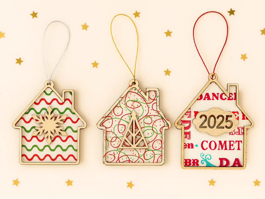 “Pack of 3 wooden house Christmas decorations with fabric backgrounds and walnut veneer fronts.”