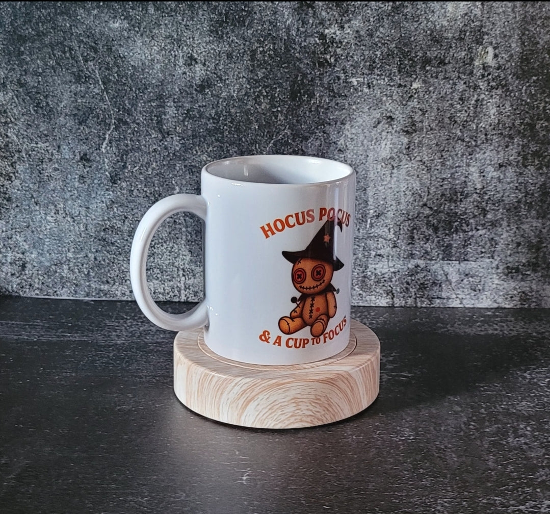 White ceramic Halloween mug with voodoo doll witch design.