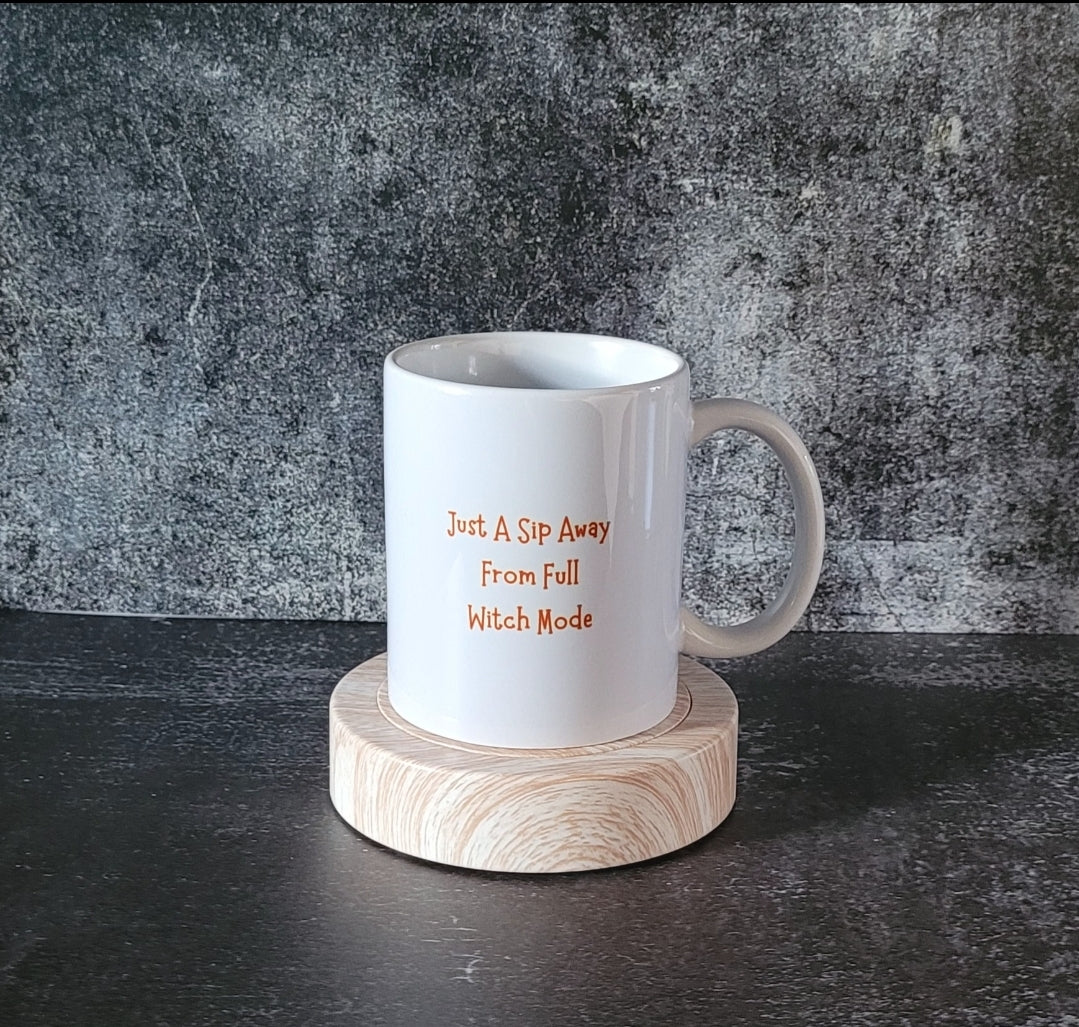 Halloween coffee cup on wooden coaster with gothic backdrop.