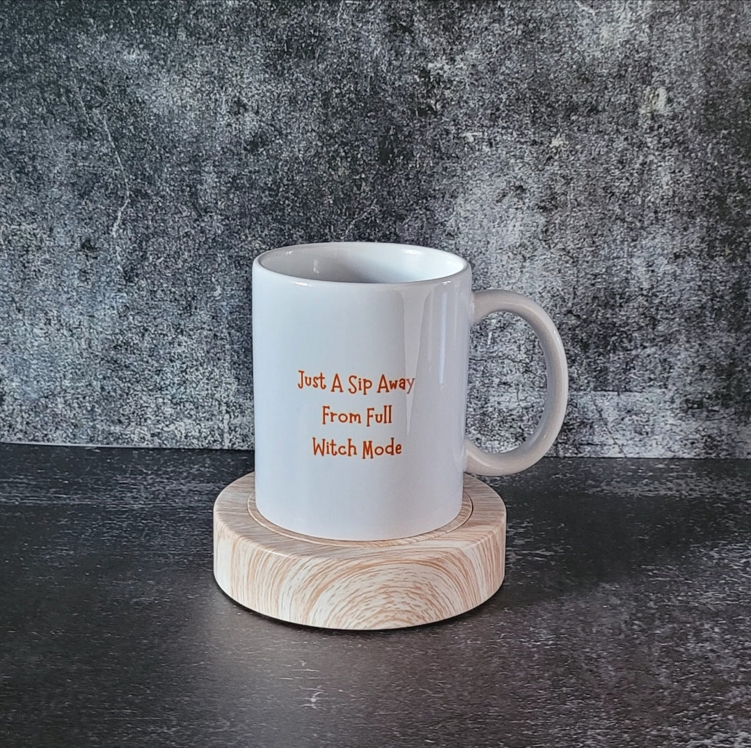 Back of mug with orange witchy quote: Just a sip away from full witch mode.