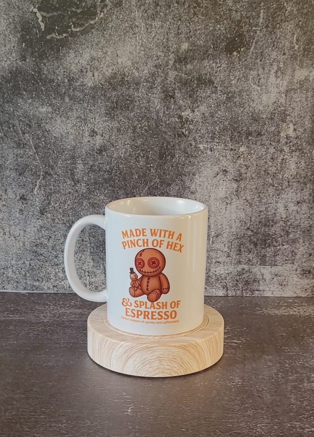 White ceramic mug with voodoo doll and pinch of hex espresso design.