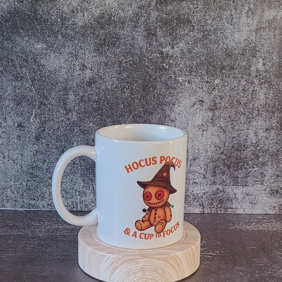 Witch mode funny mug displayed on wooden stand.