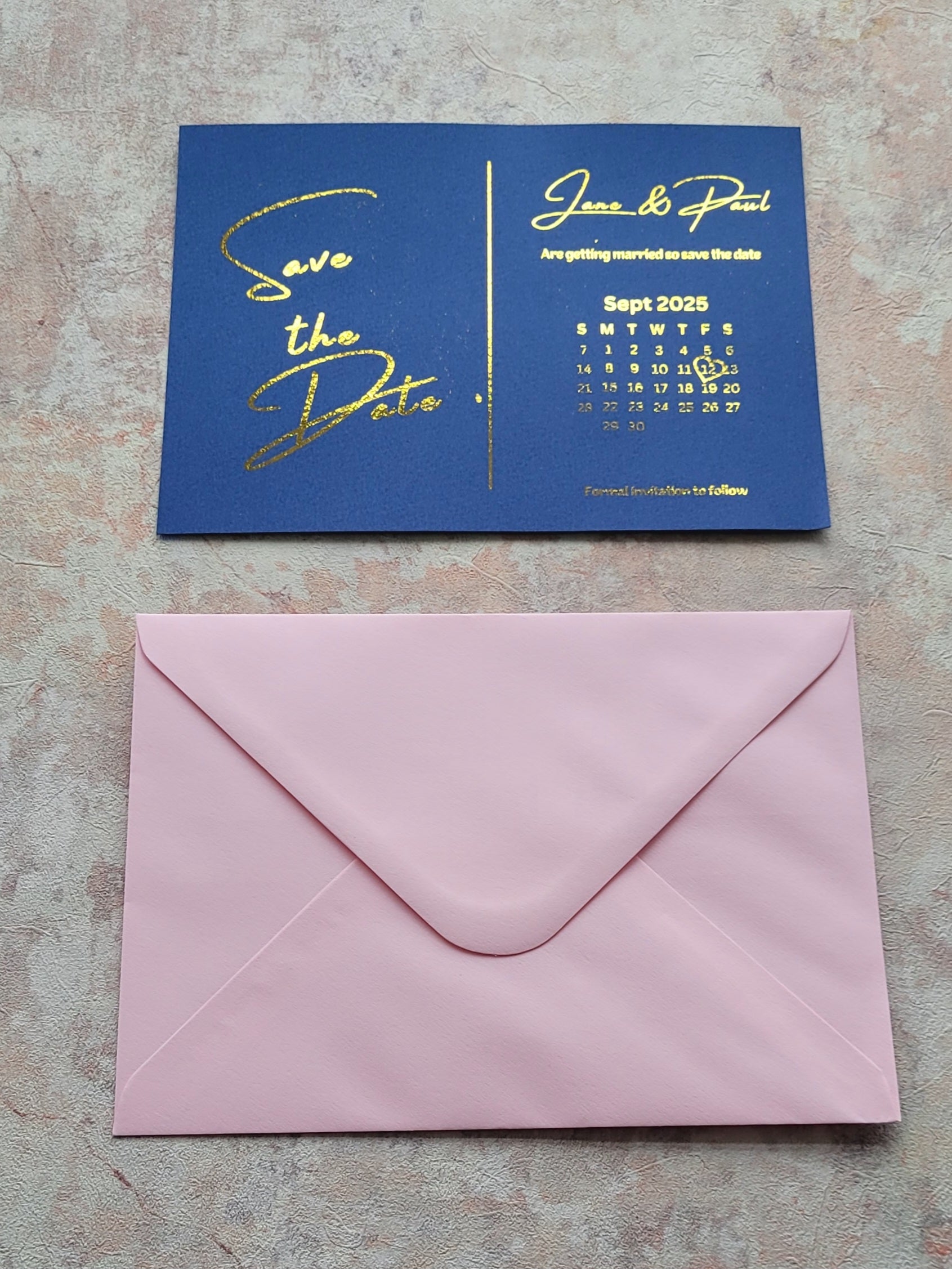 Save the date blue card with gold writing and light pink envelope 