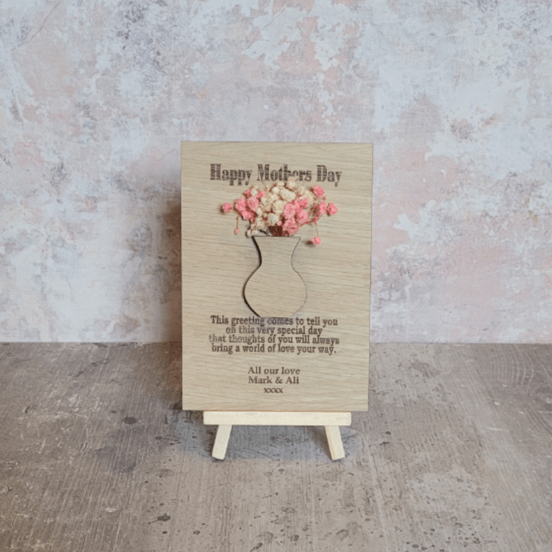 handmade wooden mother's day card. with dried flowers for mothers day on pink background