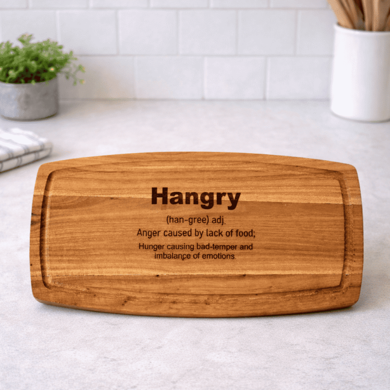hangry acacia wood engraved chopping board – 25cm x 10cm displayed on a kitchen countertop
