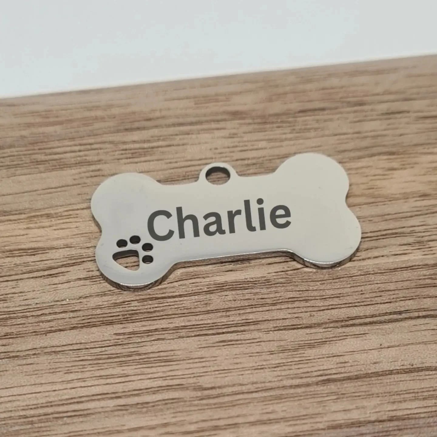 personalised stainless steel bone shaped dog name tag engraved with dog name