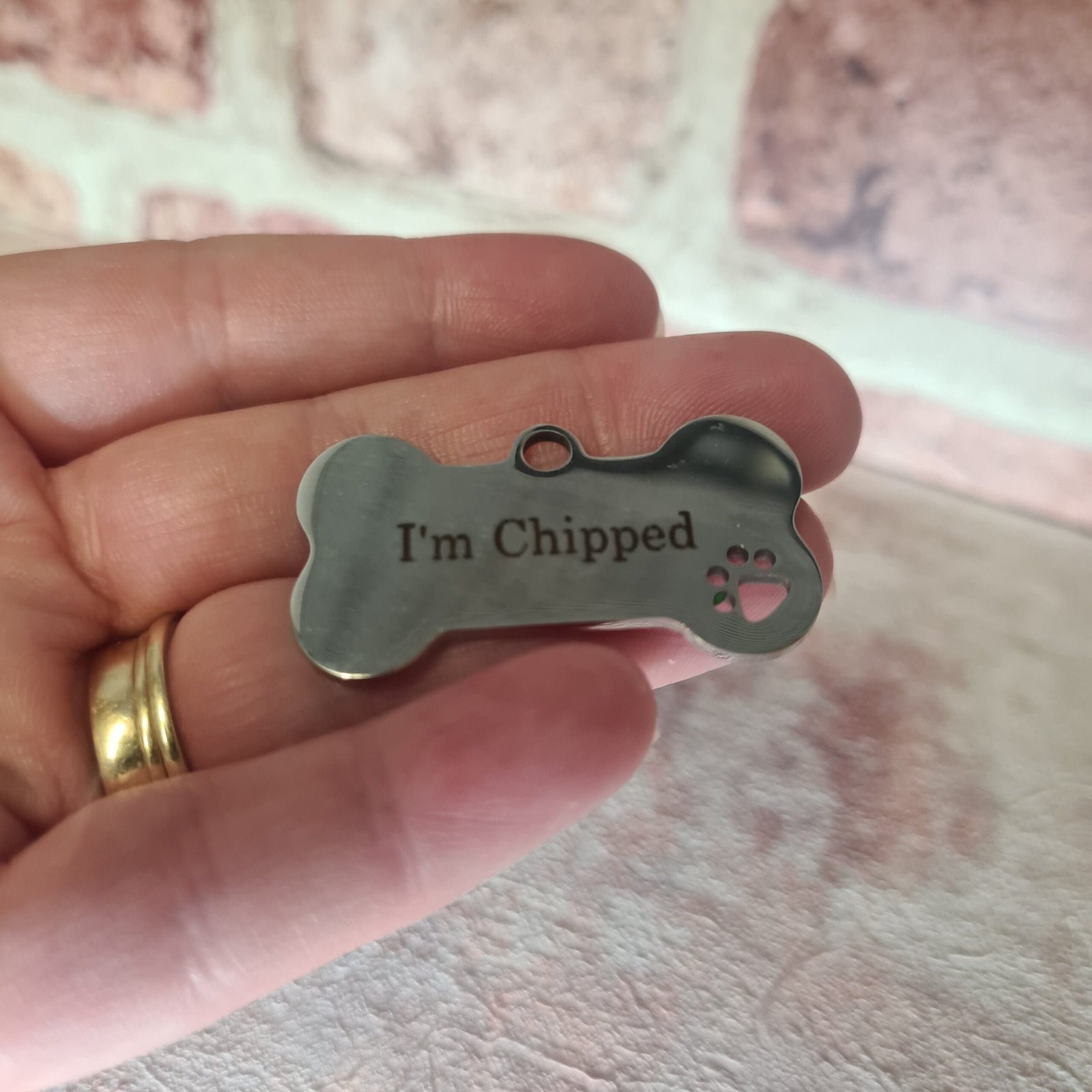 engraved stainless steel dog tag showing I'm chipped message on reverse