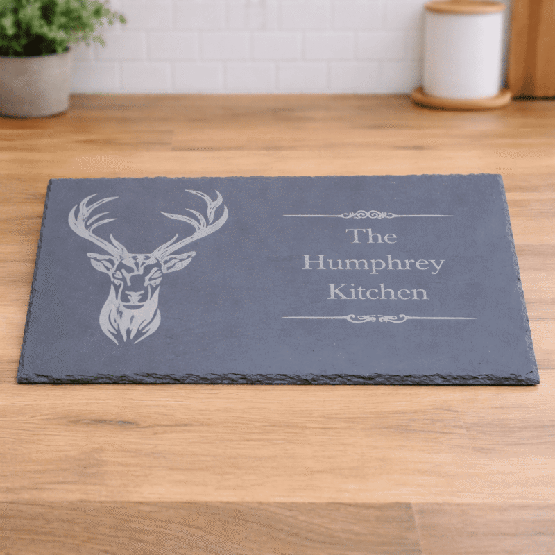 personalised engraved slate stag charcuterie board serving platter with stag design and family kitchen name laser engraved on natural slate board