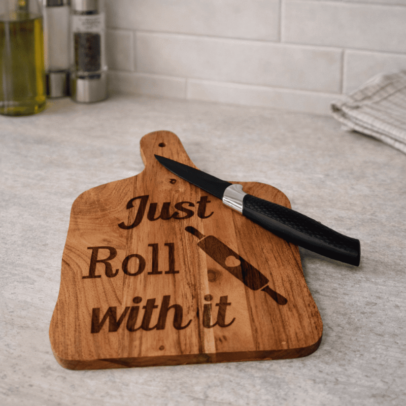 engraved wooden chopping board with just roll with it baking design and rolling pin engraving on natural wood board