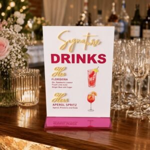 Personalised signature drinks wedding sign with white acrylic background, raised mirrored magenta 'Drinks' lettering and custom cocktail names, handmade in the UK by Laser Guided Gifts.