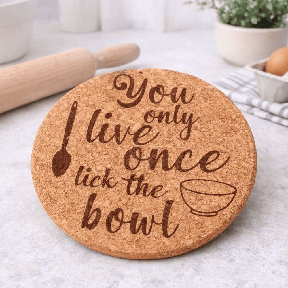 Engraved cork trivet featuring a funny cooking quote and wooden spoon design, a unique handmade gift for cooking and kitchen lovers.