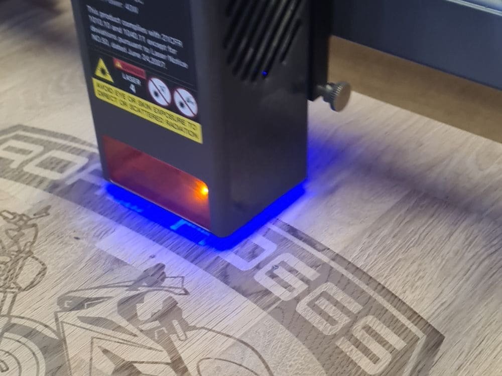 Laser engraving a personalised wooden design in the Laser Guided Gifts workshop, using precision engraving equipment to create custom handmade gifts.