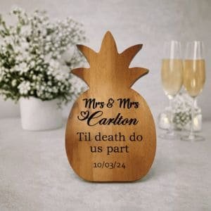 Personalised wooden pineapple wedding gift engraved with couple's names, wedding date and 'Til death do us part' design.